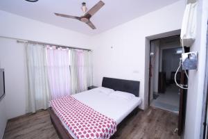 a bedroom with a bed and a ceiling fan at Aarya Stays- 1BHK near Jupiter Hospital in Thane +37 photos