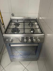 a stove top oven sitting in a kitchen at Purity Inn JVC in Dubai