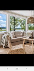 a living room with a couch and a table at Hytte ved elv in Hektner +3 photos