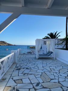 a patio with a view of the water at Elpis Rooms in Mylopotas