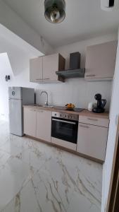 a kitchen with white cabinets and a stove top oven at Apartmani Ritoša in Novigrad Istria +26 photos