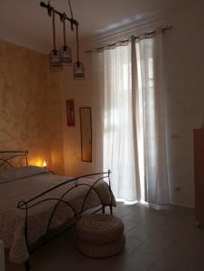 a bedroom with a bed and a large window at La ninfa B&B in Salerno