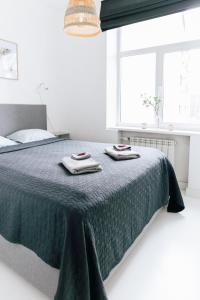 a bedroom with a bed with two towels on it at City Center Maakri Apartment in Tallinn