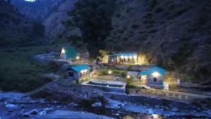 an aerial view of a house in the mountains at night at Resort Blue Lotus in Almora