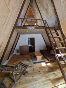 an attic room with a staircase and a chair at Resort Blue Lotus in Almora
