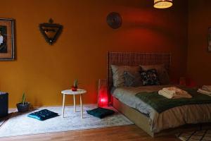 a bedroom with a bed and a table with a lamp at Sahara studio with shared bathroom in city centre in Bratislava