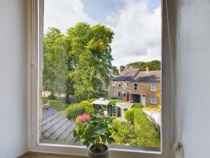 an open window with a view of a house at Acacia House in Wolsingham