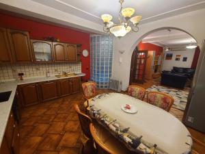 a kitchen with a table and chairs in a room at Villa My Apartments in Tirana