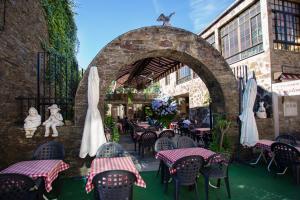an outdoor patio with tables and chairs in a building at Triacastela Sunset Terrace in Tríacastela