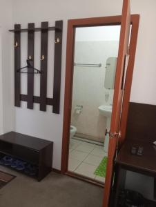 a bathroom with a toilet and a glass door at Гостиница "SEMEY-CITY" in Semey