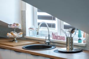 a kitchen counter with a sink and a window at Sunset view New apartment in Cavtat +41 photos