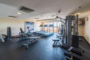 a gym with several treadmills and cardio equipment at 6pax Homestay Resort Suite 1min to Sunway Pyramid in Petaling Jaya