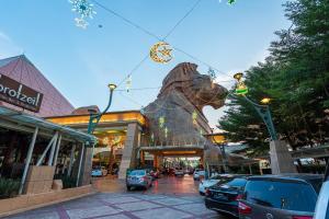 a building with a statue of a dog in front of it at 6pax Homestay Resort Suite 1min to Sunway Pyramid in Petaling Jaya