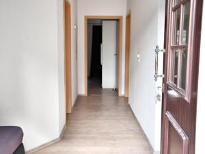 a corridor of an empty room with an open door at Ground floor apartment with terrace and large garden with lounge area and grill in Mönkebude