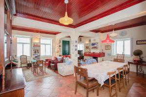 a large living room with a table and chairs at Torreira . Yellow Beach Pavilion in Torreira