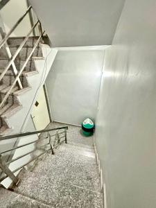 a staircase in a building with a green bowl at HOTEL PRAKASH GUEST HOUSE ! Varanasi ! fully-Air-Conditioned hotel at prime location with Parking availability, near Kashi Vishwanath Temple, and Ganga ghat in Varanasi