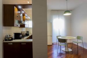 a kitchen with a table and chairs in a room at The Green House [Free Private Parking] in Milan