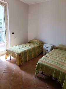 Lova arba lovos apgyvendinimo įstaigoje La Casa del Mare e della Montagna