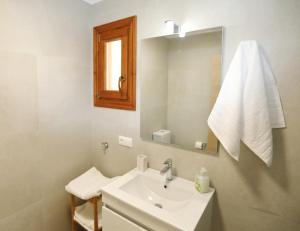 a white bathroom with a sink and a mirror at Kallichoron 3 in Kavála