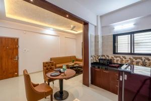 a kitchen and dining room with a table in a room at StayBird - Divine Suites, Business Hotel, Kharadi in Pune