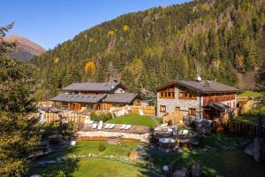 an aerial view of a house in the mountains at La Tana dell'orso Hotel & SPA in Ponte di Legno