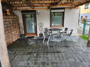 a patio with a table and chairs on it at Ferienwohnung Marquard's in Immendingen