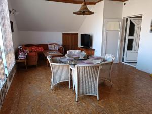 a living room with a table and chairs and a couch at Jablanicki Refugium in Pružatovac +15 photos