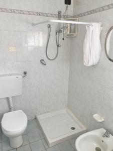 a bathroom with a shower and a toilet and a sink at Appartamento Meri, Montecatini Terme in Montecatini Terme