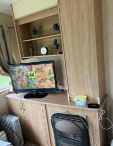 a television sitting on top of a wooden table at Blue Beach Retreats Ltd in Mablethorpe