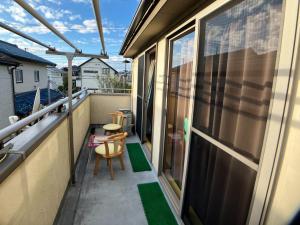 a balcony with a chair and a table at Akane Shimada House - Vacation STAY 13990 in Narashino