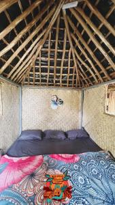a bed in the middle of a room at Woodman Hideout in Kanthalloor