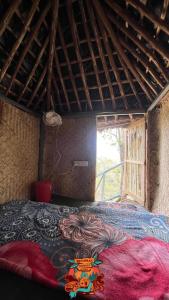 a room with a bed in a room with a window at Woodman Hideout in Kanthalloor
