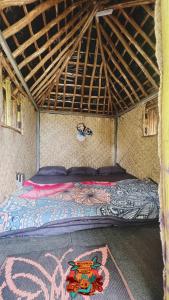 a bed in a room in a tent at Woodman Hideout in Kanthalloor