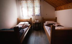 Duas camas num pequeno quarto com uma janela em Eko Stevanovac em Mojkovac