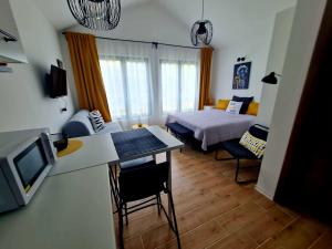 sala de estar con cama y habitación con cocina en Apartman VIN 5, en Divčibare