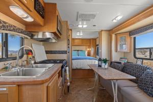 a kitchen with a sink and a bed in a room at JT Village Campground - Casa Pequena in Joshua Tree