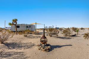 a bottle in the middle of the desert at JT Village Campground - Casa Pequena in Joshua Tree +5 photos