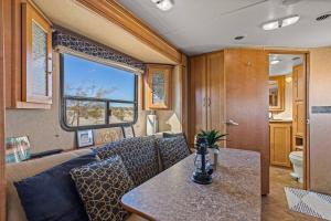 an rv living room with a couch and a table at JT Village Campground - Casa Pequena in Joshua Tree