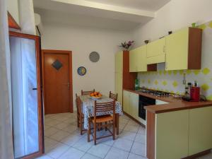 a kitchen with a table and a dining room at B&B Casa Mena in Vietri sul Mare