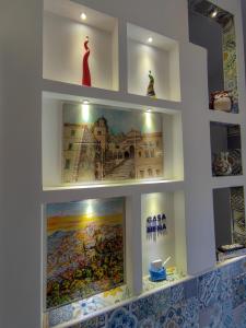 a shelf in a store with a painting on it at B&B Casa Mena in Vietri sul Mare