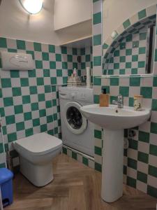 a bathroom with a washing machine and a sink at B&B Casa Mena in Vietri