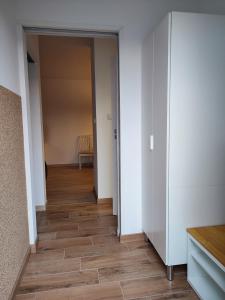 an empty room with a hallway with wood floors at Mieszkanie z ogrodem in Gdańsk