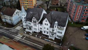 an aerial view of a large white building with a turret at Apartament Loftowy Ordona 5 in Szczecinek