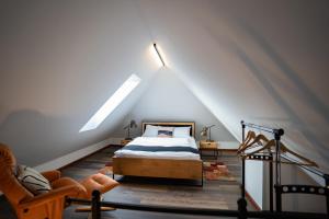 a bedroom with a bed in a attic at Apartament Loftowy Ordona 5 in Szczecinek