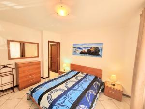 a bedroom with a bed and a painting on the wall at Apartamento Real Delux in Vila Real de Santo António