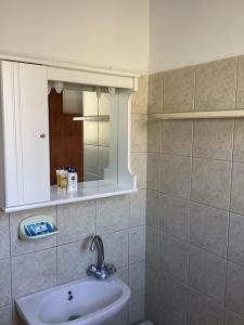 a bathroom with a sink and a mirror at Vista del Mare Rooms 1 in Agios Ioannis Kaspaka +21 photos