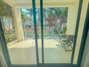 an open door to a patio with a table and a chair at Paradise Resort Doc Let in Doc Let