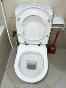 a white toilet with the lid up in a bathroom at Ft 22 R1 Luxury Room attach bath Seaview Beach access Ajman غرفة فاخرة مع إطلالة على البحر وإمكانية الوصول إلى الشاطئ in Ajman 