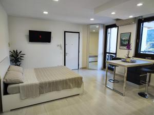a bedroom with a bed and a table and a desk at Appartamento La Terrazza - Paratico - in Paratico