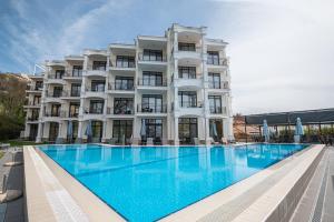 a large white building with a large swimming pool at Hotel Samara with Relax area in Balchik